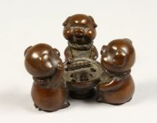 A GROUP OF THREE BRONZE PIGS PLAYING DICE 2.5ins