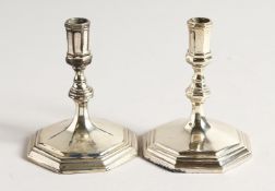 A PAIR OF CAST SILVER CANDLESTICKS 3.5ins high London 1969