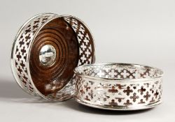 A PAIR OF PLATE SILVER AND WOOD CIRCULAR WINE COASTERS 5ins diameter.