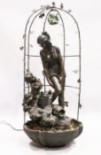 A FINE BRONZED WATER FEATURE, a classical female and Cupid standing on a metal base and arbour.