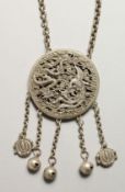 A CHINESE SILVER YIN-YANG PENDANT on a chain with dragon and phoenix.