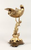 A GILT BRONZE OF A CLASSICAL YOUNG LADY holding aloft a shell.