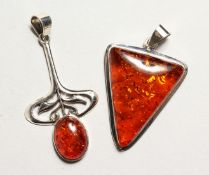 TWO SILVER AND AMBER PENDANTS