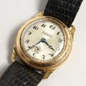 A HARWOOD GOLD WRISTWATCH with leather strap.
