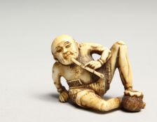 A CARVED BONE NETSUKE OF AN ONI 1.5ins