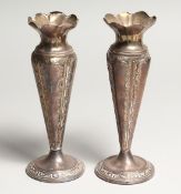 A PAIR OF SILVER VASES on circular loaded bases Birmingham 1917 6ins high.