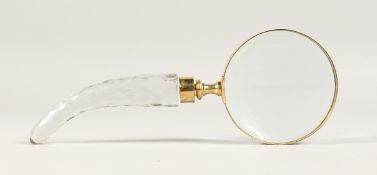 A MAGNIFYING GLASS with a cut glass handle.