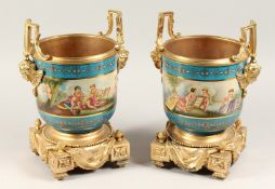 A GOOD PAIR OF ORMOLU AND PORCELAIN SEVRES DESIGN CIRCULAR CACHE POTS painted with classical