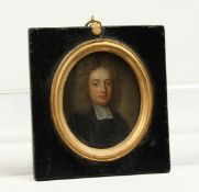 A SMALL 18TH CENTURY OVAL MINIATURE OF A CLERK, on copper. 2ins x 1.75ins