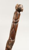 A CARVED FOLK ART STICK 36ins long