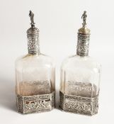 A VERY GOOD PAIR OF EUROPEAN SILVER MOUNTED ETCHED GLASS RECTANGULAR WINE BOTTLE, the glass etched