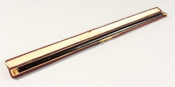 A LONG FRENCH CHERRY AMBER/ BAKELITE CIGARETTE HOLDER 15ins long in a leather case