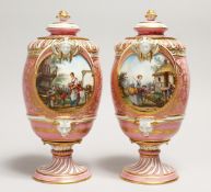 A VERY GOOD PAIR OF SEVRES PINK GROUND VASES AND COVERS each painted with reverse panels of figures,