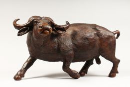 A HEAVY CARVED WOODEN OX. 2ft long.