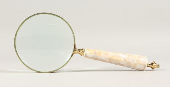 A MAGNIFYING GLASS with a mother of pearl handle.