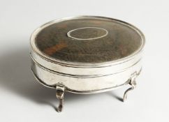 A GEORGE V SILVER AND TORTOISESHELL OVAL PIN BOX on four curving legs. 4.75ins long, London 1912.