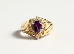 A 14CT GOLD, AMETHYST AND DIAMOND TEAR DROP RING