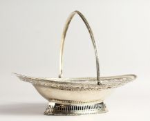 A FINE GEORGE III SILVER CAKE BASKET by HESTER BATEMAN with bead edges and swing handles. London