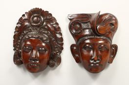 A PAIR OF EARLY CARVED HARDWOOD MASKS