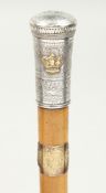 A 19TH CENTURY CEREMONIAL CANE with engraved silver top with a crown. 35ins long.
