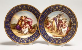 A GOOD PAIR OF VIENNA PORCELAIN PLATES,rich blue gilt borders, the centres painted with classical