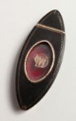 A GEORGE III NAVETTE SHAPED TORTOISESHELL AND GOLD SNUFF BOX, the hinged cover inset with a glass