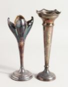 TWO SILVER FLOWER VASES on circular loaded bases 7ins & 8ins high.