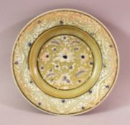 A GREEN GLAZED TIMURID POTTERY DISH, with floral motif decoration, 21cm