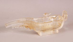 A CHINESE CARVED GLASS LIBATION CUP, with archaic decoration, 17cm wide.