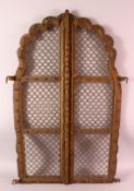A PAIR OF INDIAN CARVED ROSEWOOD ARCHED WINDOW SHUTTERS, with wire work infill's, 87cm x 27cm