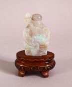A CHINESE OPALITE CARVED SNUFF BOTTLE & STAND, carved depicting a fish, 4.5cm