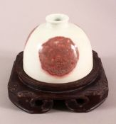 A CHINESE COPPER RED GLAZED PORCELAIN BRUSH POT, with roundel decoration, underside with a six