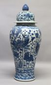 A LARGE 20TH CENTURY KANGXI STYLE BLUE AND WHITE FLOOR STANDING VASE AND COVER, the body painted