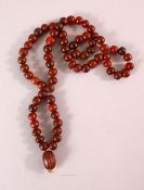 A RHINO HORN BEAD NECKLACE, beads approx 10mm diameter, weight 65g.