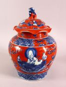 A CHINESE CORAL RED GROUND UNDERGLAZE BLUE PORCELAIN GINGER JAR & COVER, decorated with immortals in