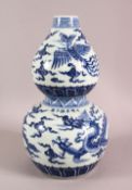 A CHINESE BLUE & WHITE DOUBLE GOURD PORCELAIN VASE, the body with a dragon and phoenix with