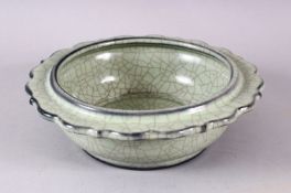 A CHINESE BARBED RIM GUAN GLAZED POTTERY DISH, the flared rim with ironwire style body decoration,