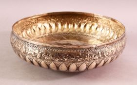 A 19TH CENTURY INDIAN SILVER BOWL, with pressed decoration on three feet, 24cm
