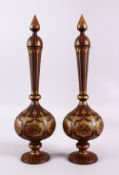 A PAIR OF ISLAMIC DAMASCENE INLAID STEEL BOTTLE & COVERS, each with gold inlaid panels of star
