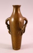 AN 18TH / 19TH CENTURY CHINESE BRONZE TWIN HANDLE VASE, the handles moulded in the form of prunus,