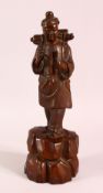 A 19TH CENTURY CHINESE CARVED WOODEN FIGURE OF A TRAVELLER, 32cm