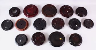 A MIXED LOT OF 15 CHINESE CARVED HARDWOOD STANDS - each of varying size, style and timber, the