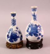 TWO CHINESE BLUE & WHITE PORCELAIN VASES & STANDS, each with floral & fruit decoration, each with