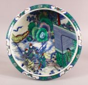 A CHINESE FAMILLE VERTE KANGXI STYLE PORCELAIN DISH, with figures on horseback in landscapes, the