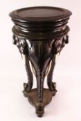 A LARGE INDIAN CARVED EBONISED WOOD AND IVORY ELEPHANT FORMED TRIPOD TABLE, the legs formed as