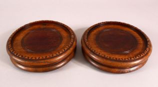 A PAIR FO 19TH CENTURY CHINESE CARVED HARDWOOD STANDS, housing a vase no larger than 12.8cm .