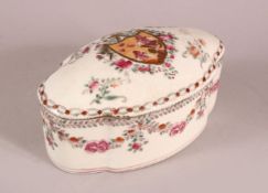 A CHINESE FAMILLE ROSE PORCELAIN BOX AND COVER, with floral decoration and a central crest, mark