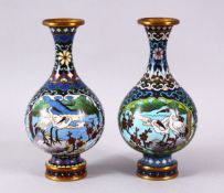 A PAIR OF CHINESE CLOISONNE CRANE VASES - each of the globular formed vases with two main panels
