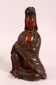 A CHINESE LACQUERED WOOD FIGURE OF GUANYIN, in a seated pose, 25.5cm