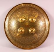 AN INDIAN ENGRAVED BRASS & SILVERED SHIELD, the shield with engraved floral motif decorations,
